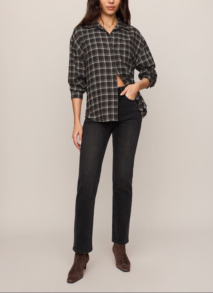 Dark plaid button-up shirt with collar and button front, styled with dark jeans