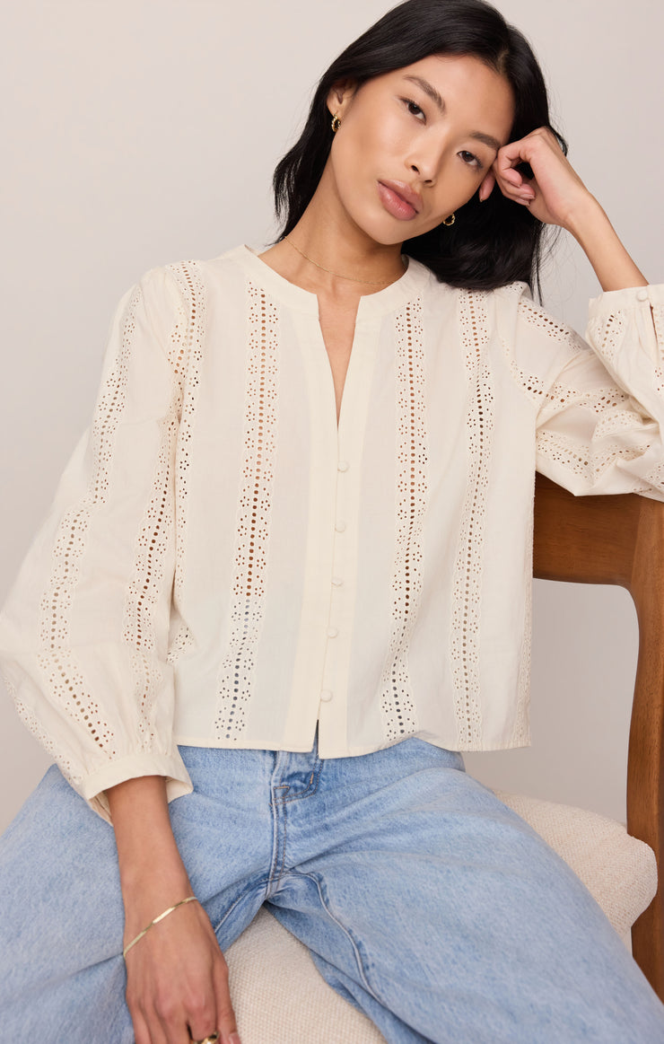 Off-white embroidered button-up top with V-neck front and cuffed puff sleeves