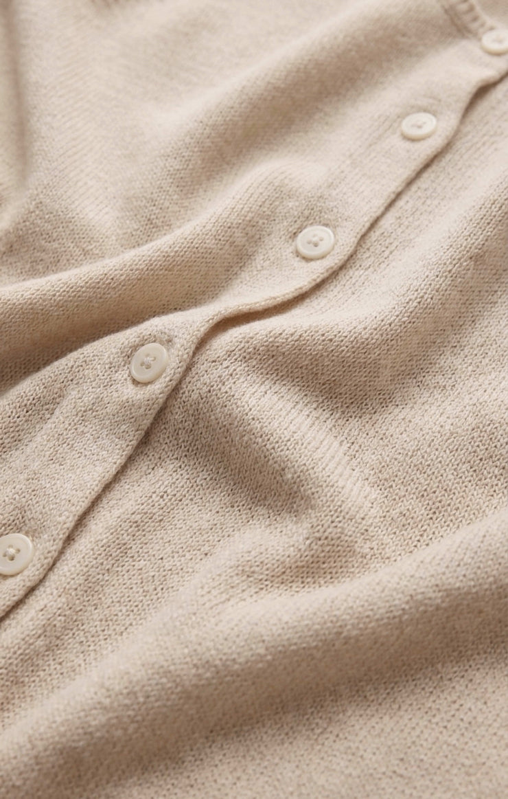 Sandstone knit fabric with rounded buttons along the front placket