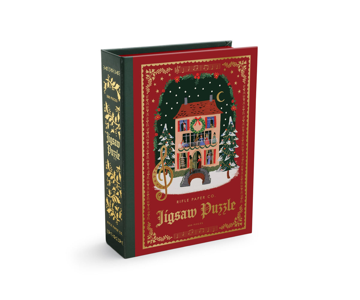 Christmas carols jigsaw puzzle box with illustrated holiday house and trees