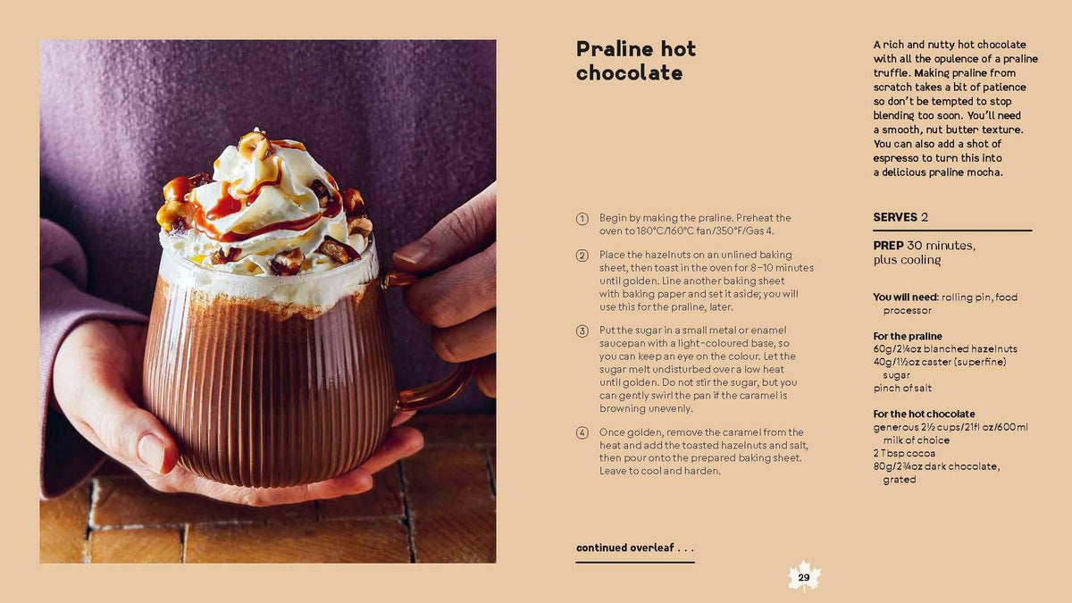 Hand holding a praline hot chocolate in a glass mug
