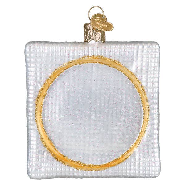 Round cross-stitch Christmas ornament back panel with gold trim and gold hanger loop
