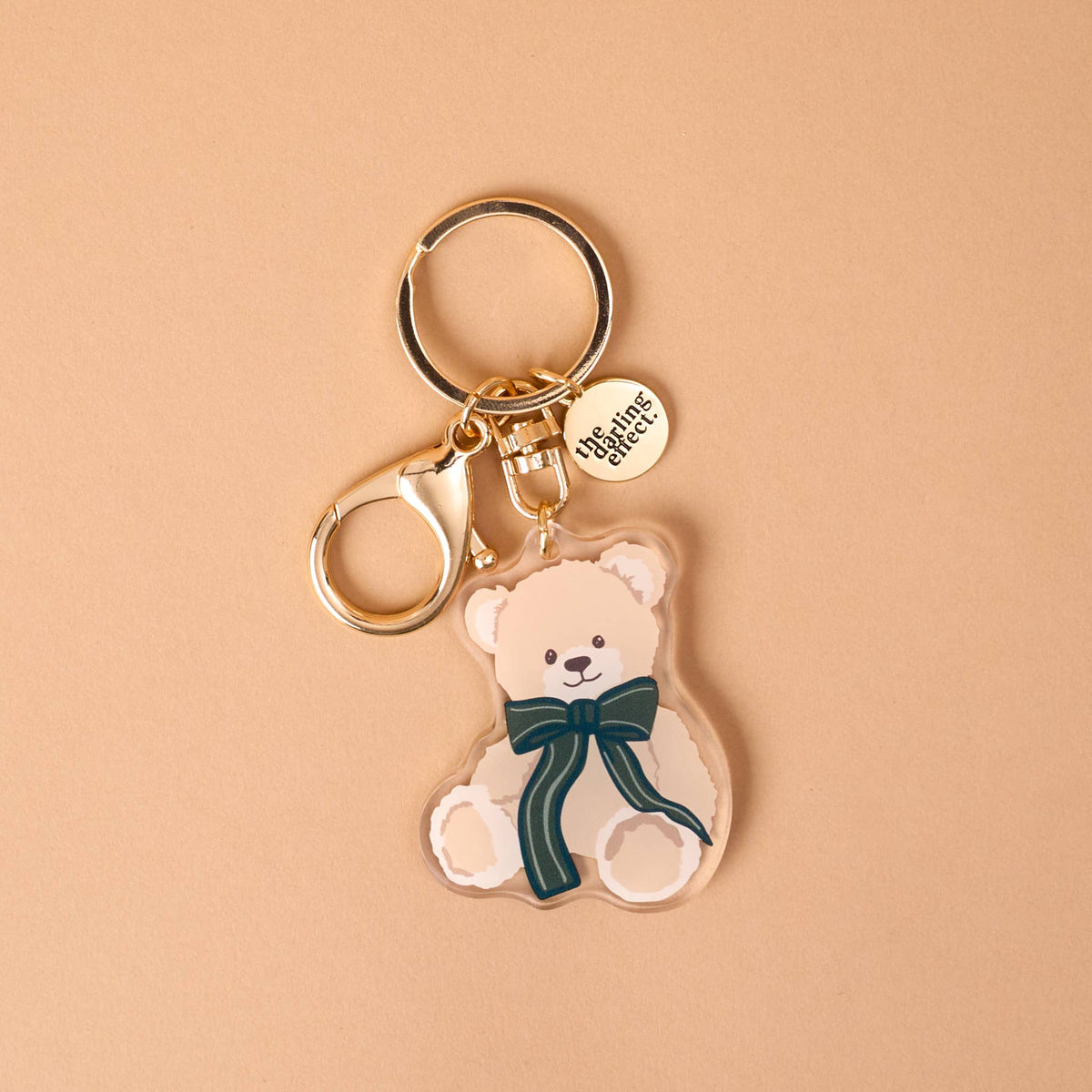 Teddy bear acrylic keychain with teal bow and round Theo charm tag