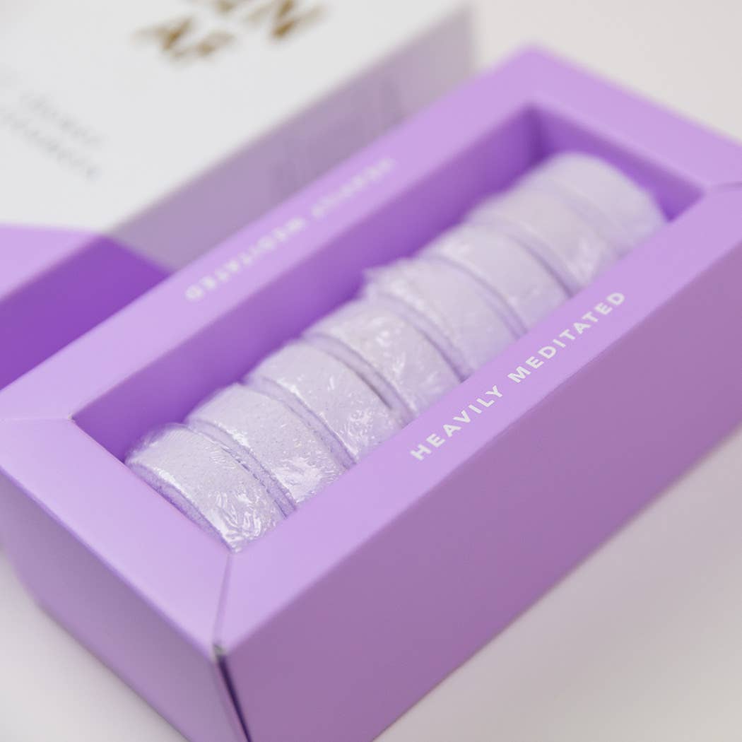 Lavender-rosemary shower steamer tablets, stacked purple domes in the box