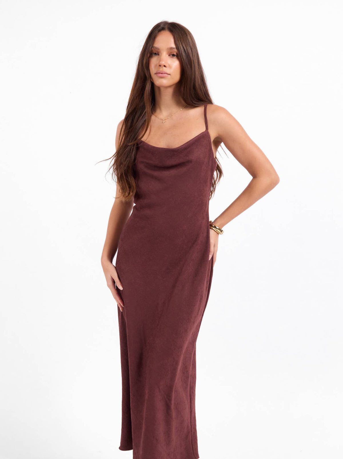 Burgundy slip dress with spaghetti straps and draped neckline, fitted midi length.