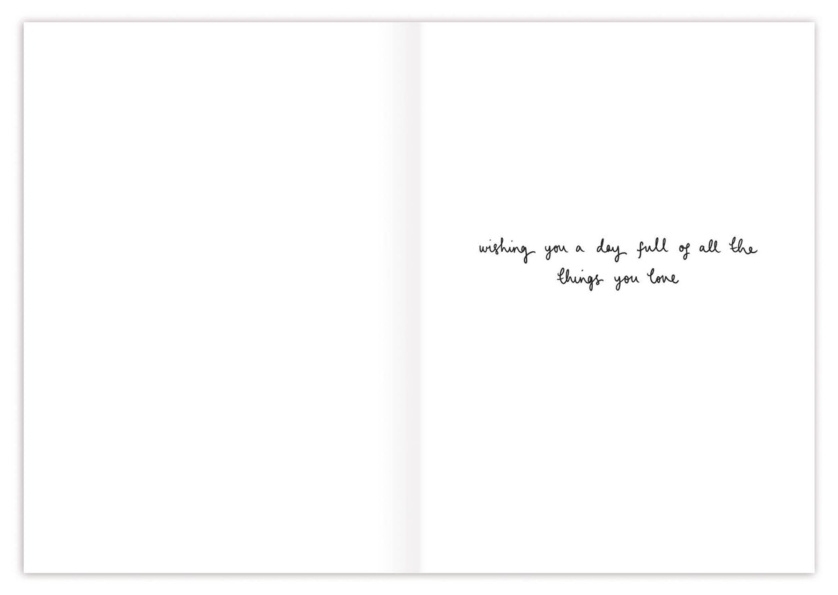 Open birthday card interior with small cursive message: “wishing you a day full of all the things you love”
