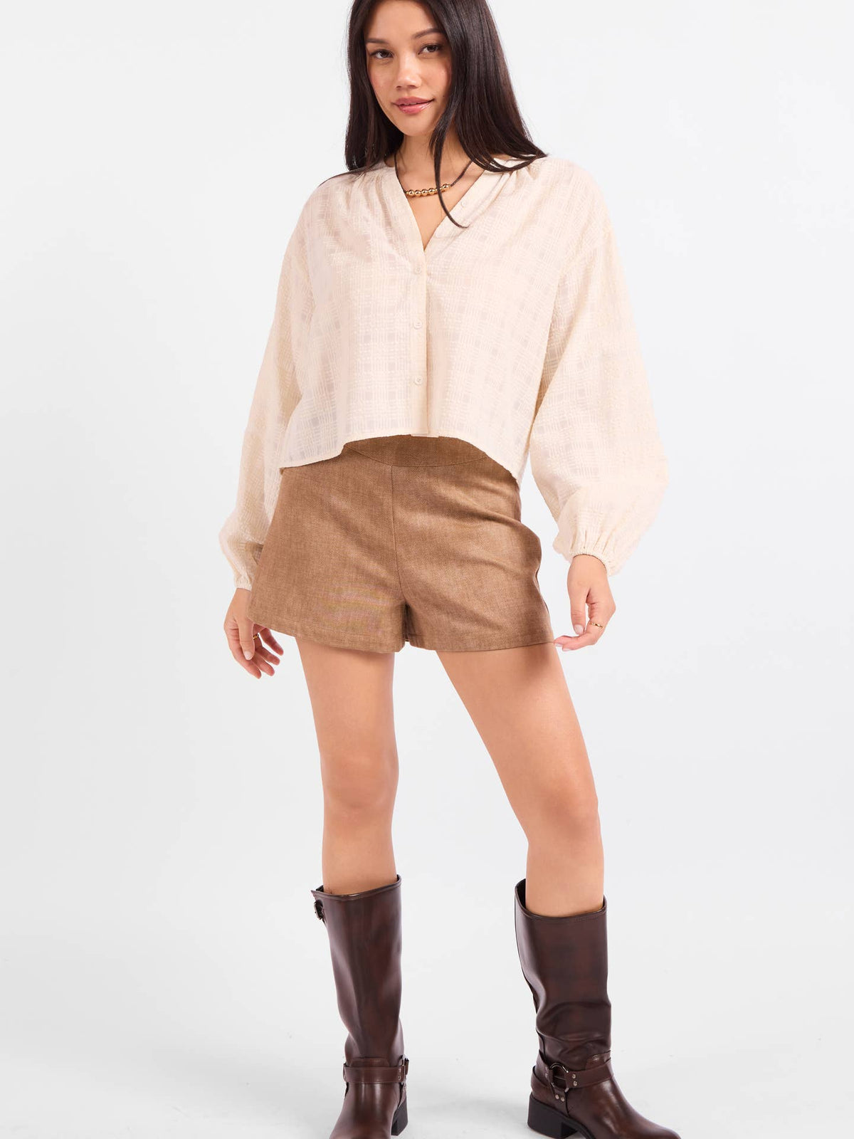 Light beige cropped blouse with V-neck buttons and gathered long sleeves