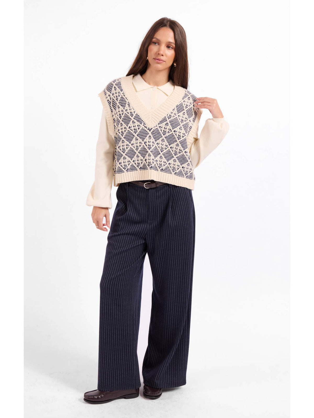 Cream geometric knit sweater vest with V-neck and ribbed hem and armhole trim
