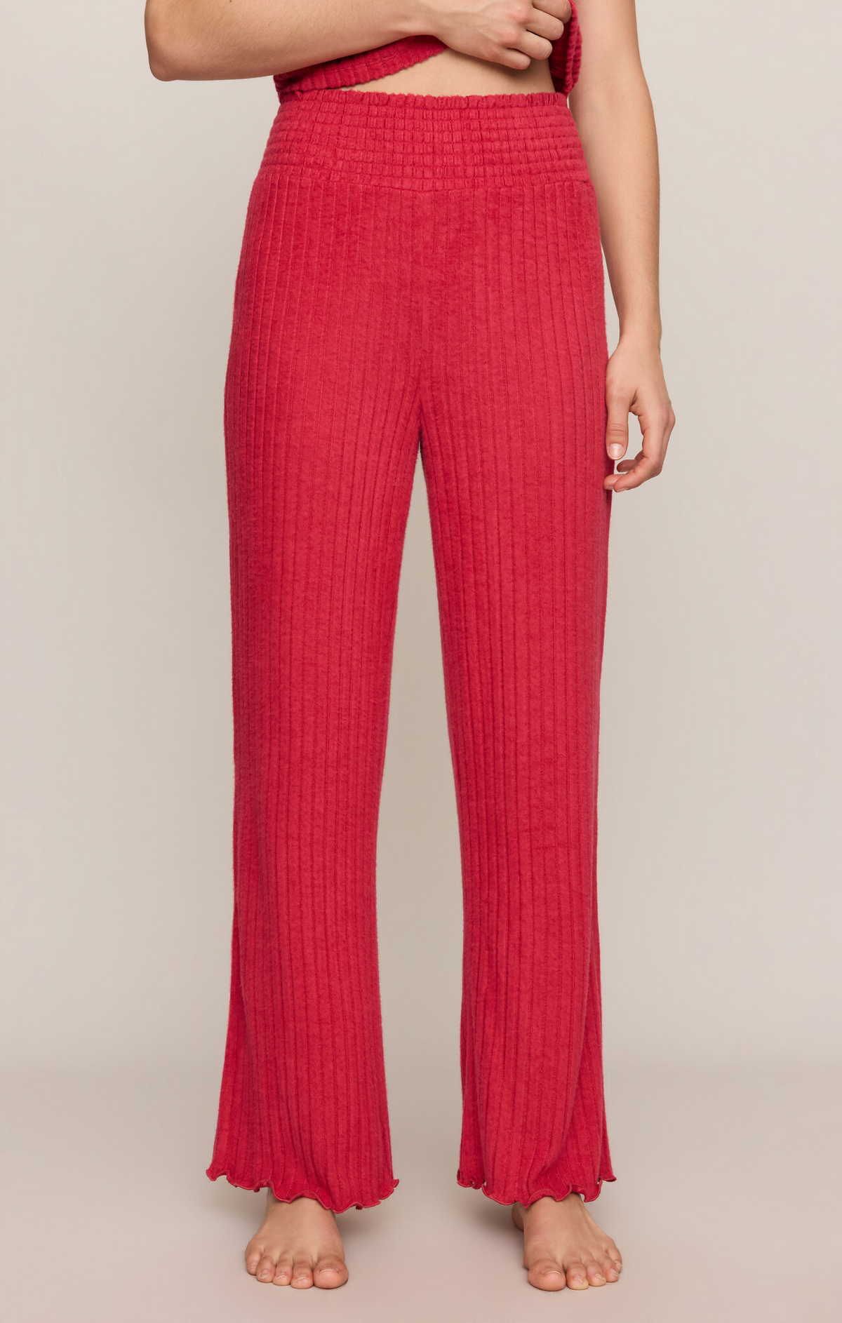 Ruby red smocked rib pants with wide-leg flare and gathered elastic waist