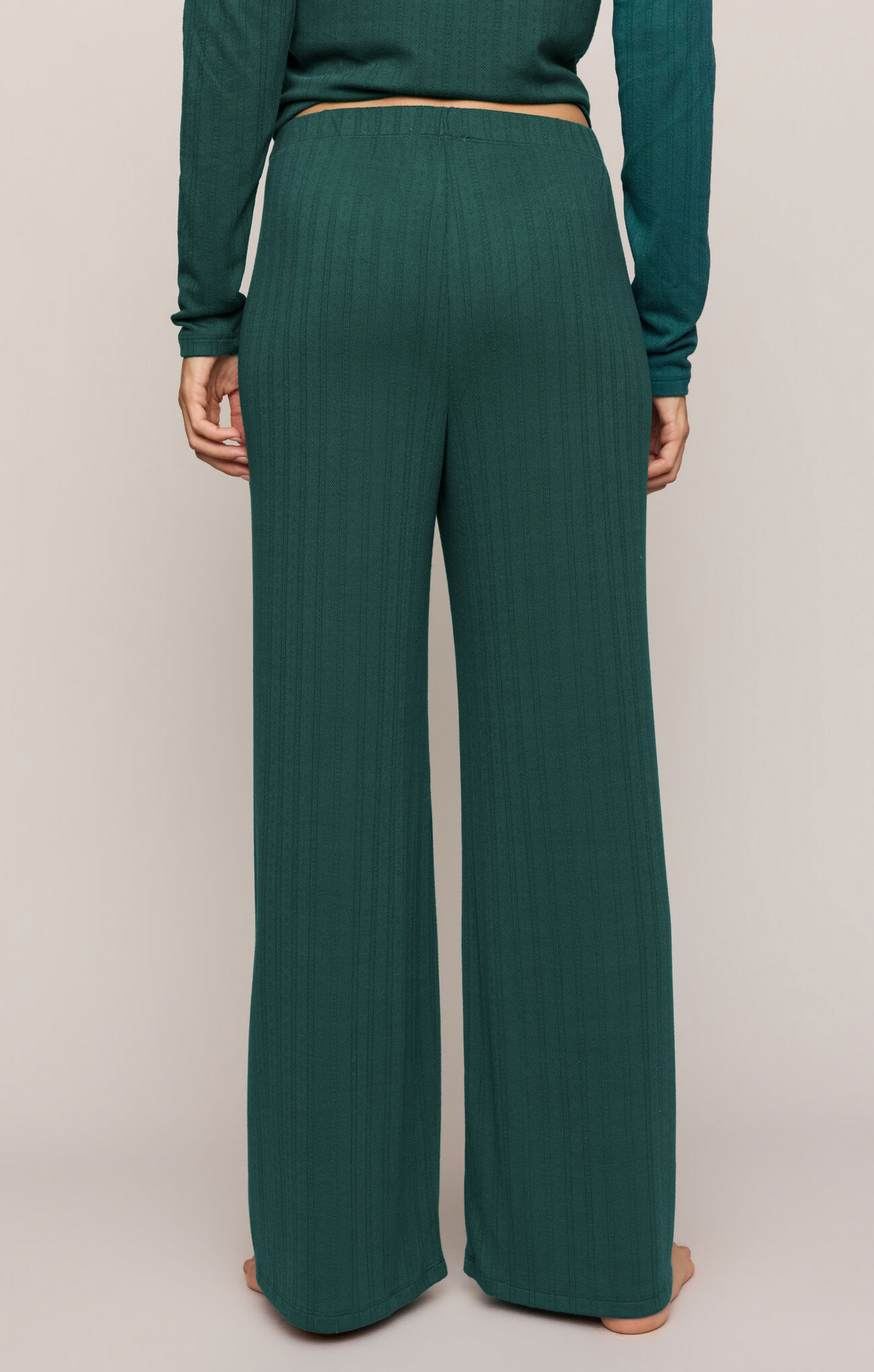 Green velvet knit pants with elastic waistband, wide straight legs, full length view