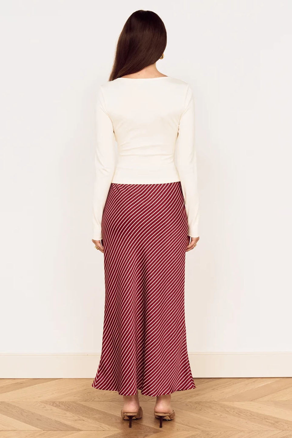 Back view: red and white striped midi bias skirt, flowy flared cut.