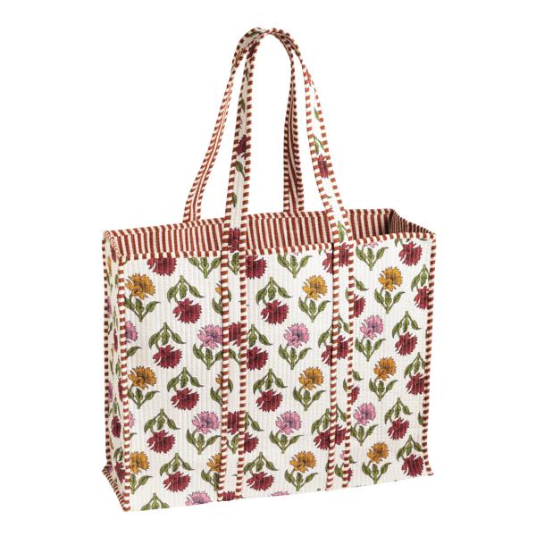 White block-print tote bag with colorful floral pattern and braided striped handles