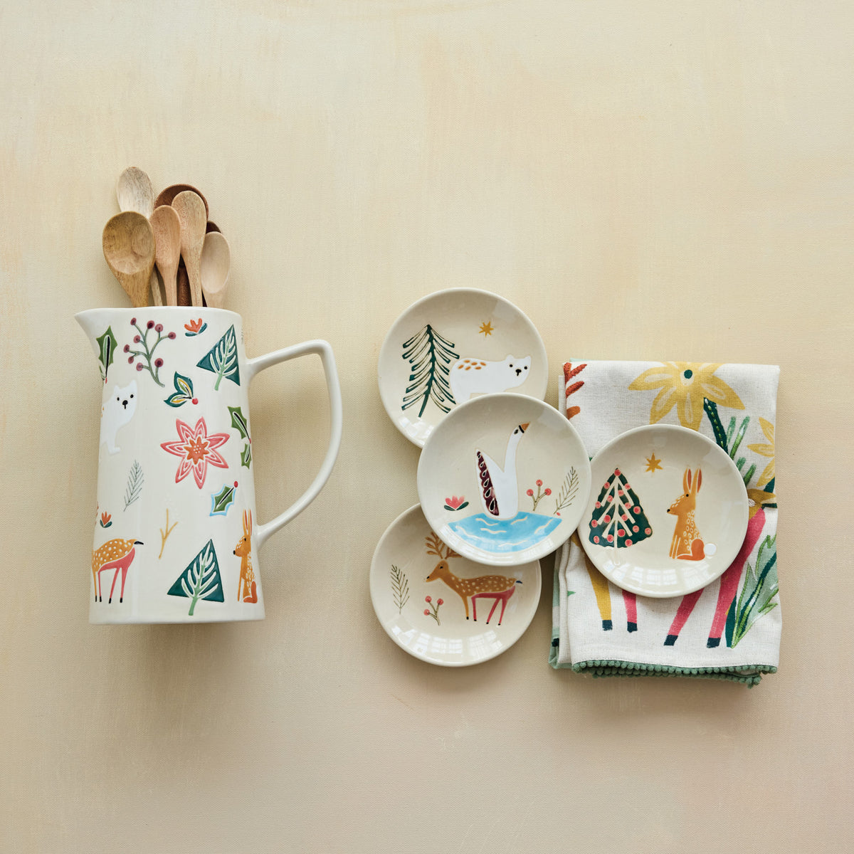 Cream stoneware pitcher with handle and seasonal animal motif, wax-relief style