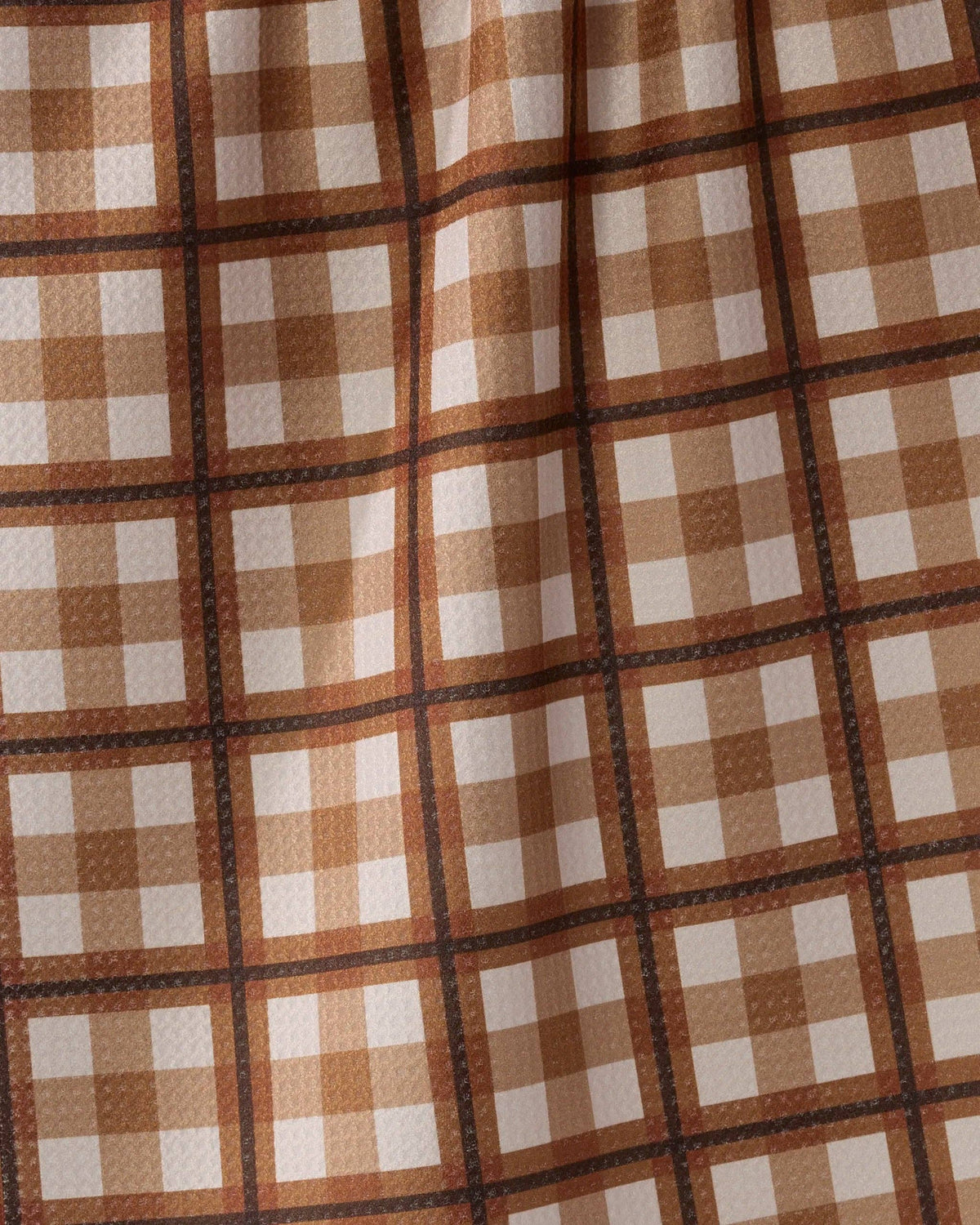 Close-up of brown and cream checkered tea towel fabric grid