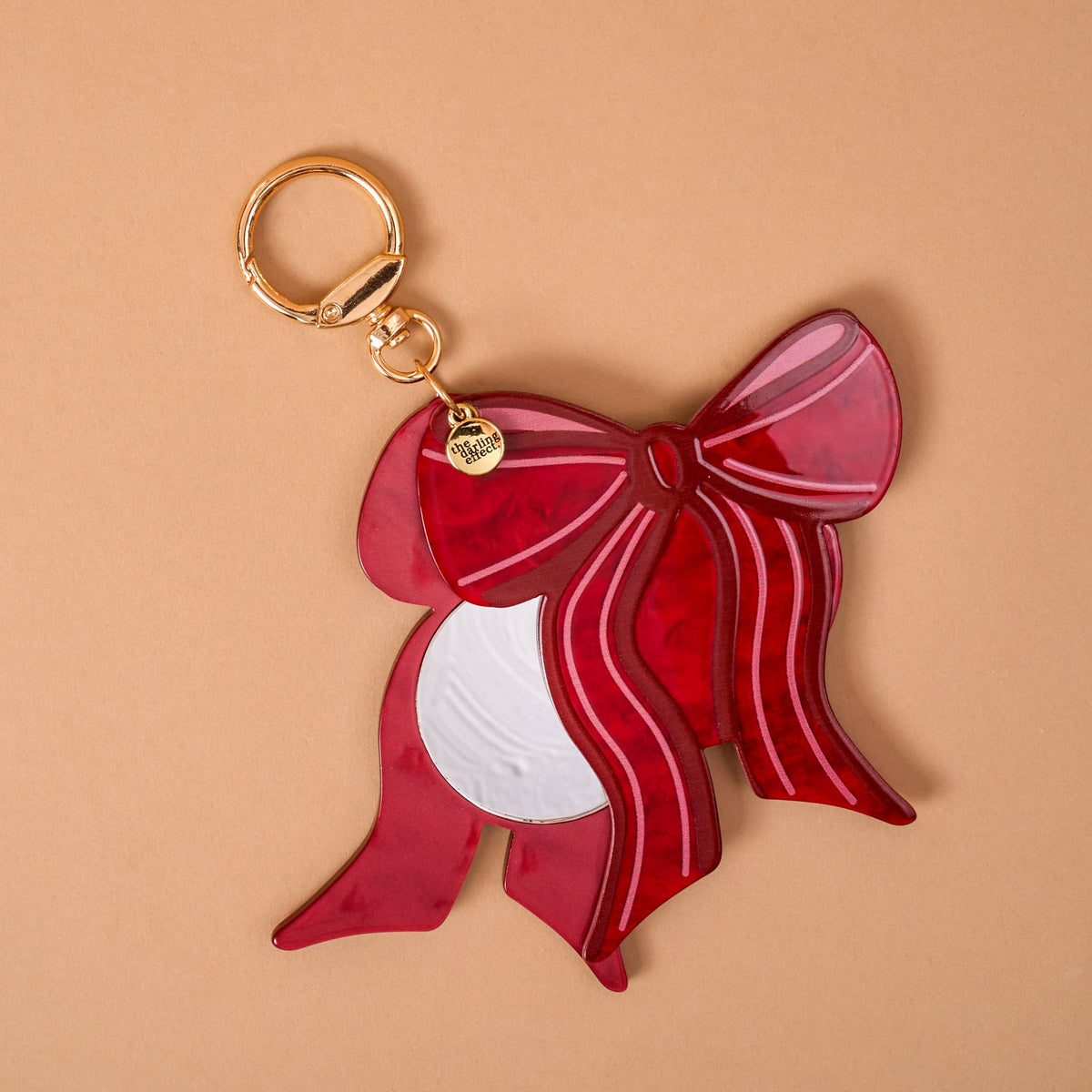 Red bow mini mirror bag charm with gold keyring and reflective mirror panel