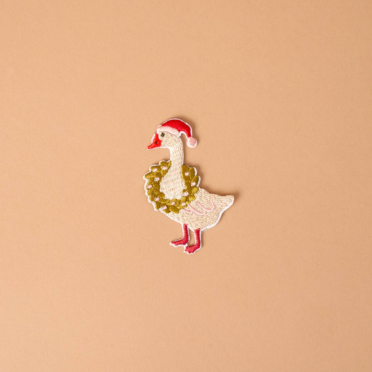 Embroidered iron-on silly goose patch with red cap and gold leafy details