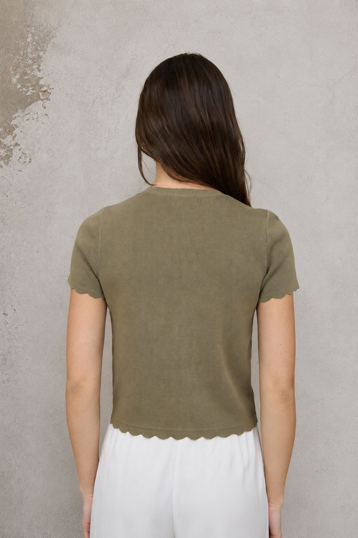 Olive cardigan top, short sleeves, back view with scalloped hem detail