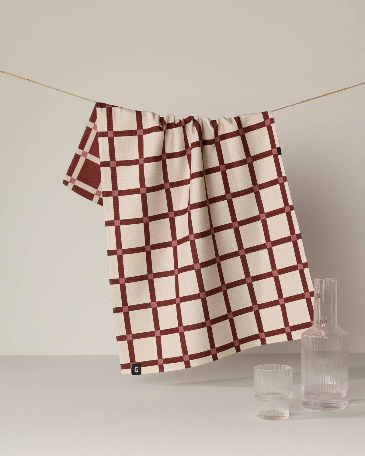 Red and white checkered kitchen towel with gathered top and hanging loop