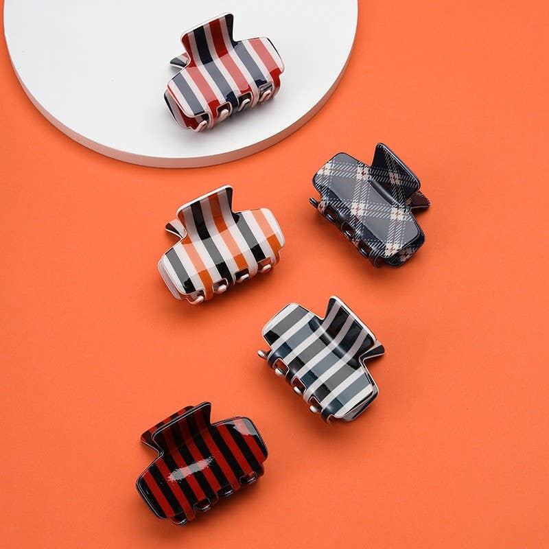 Assorted striped and plaid hair claw clips in navy, orange, and red