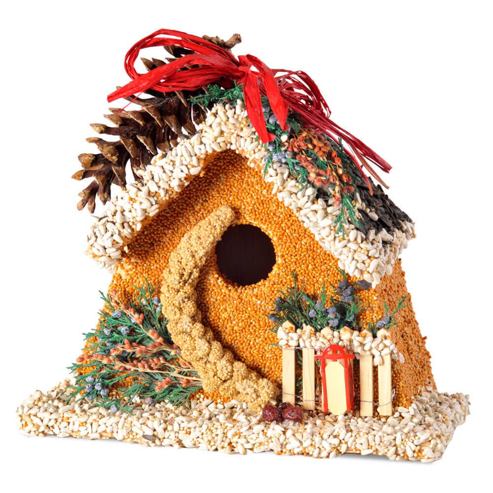 Decorative birdhouse ornament with red ribbon, pinecone roof, and three candle lights