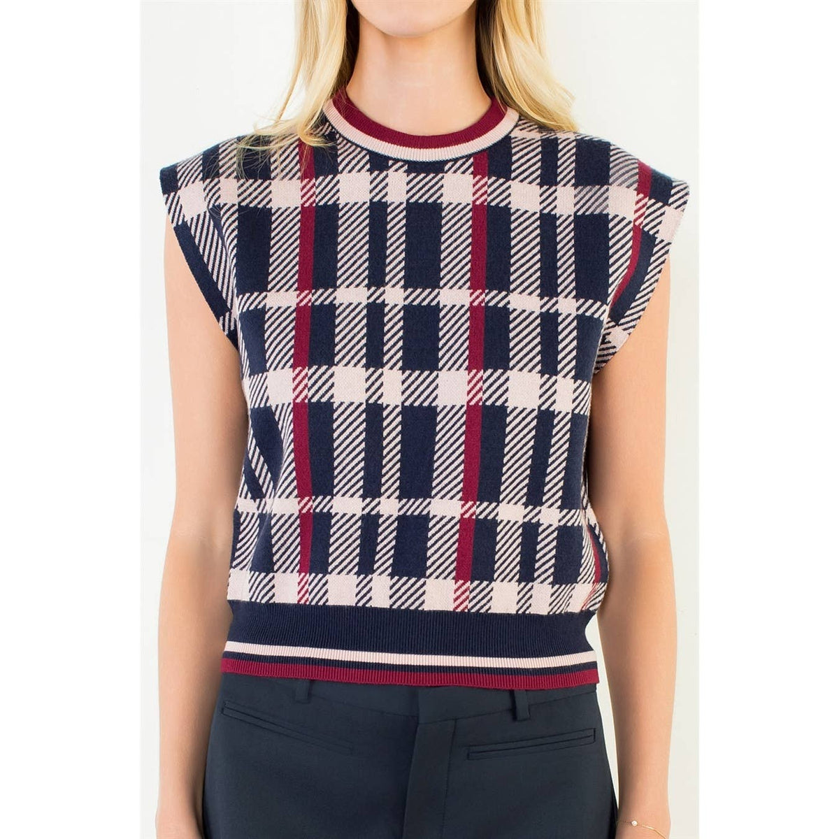 Plaid knit sweater vest close-up with red navy cream pattern and ribbed crew neckline