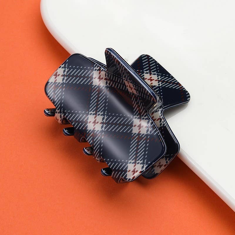 Black plaid hair claw clip with five prongs and dark enamel finish
