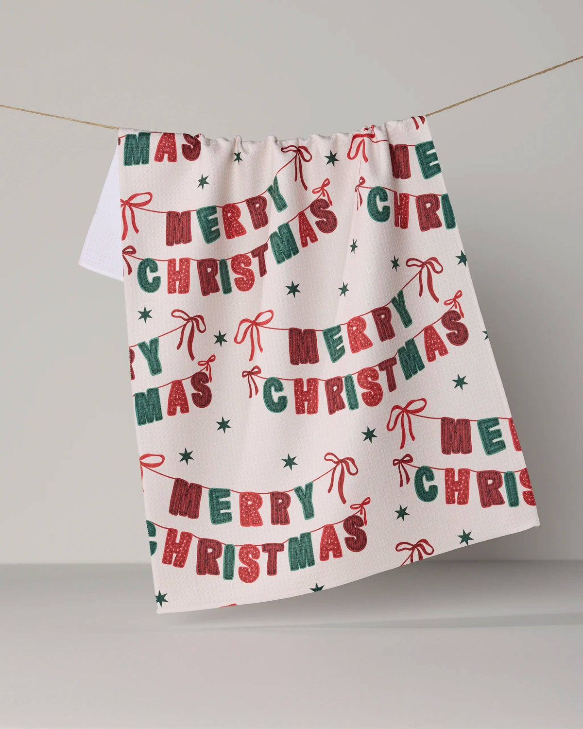 Christmas banner tea towel with Merry Christmas lettering in red and green