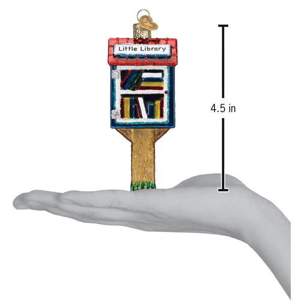 Library ornament on gold post held above hand; 4.5 in tall