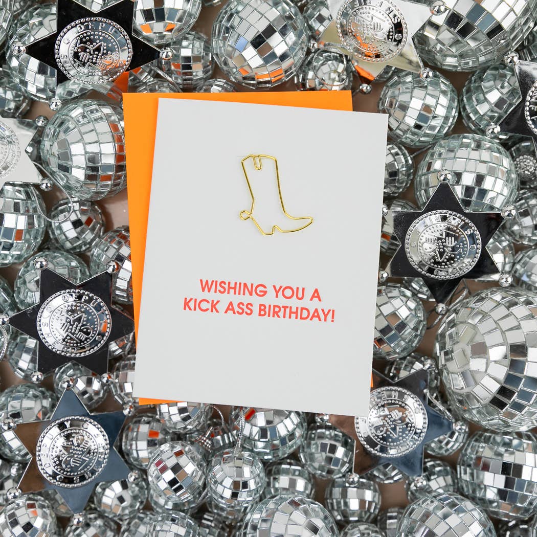 Birthday letterpress card with gold boot icon and red 'kick ass birthday' message, orange backing.
