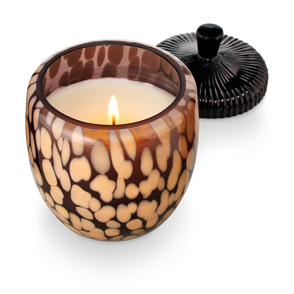 Midnight Pumpkin glass candle with black acorn lid and amber leaf-patterned jar