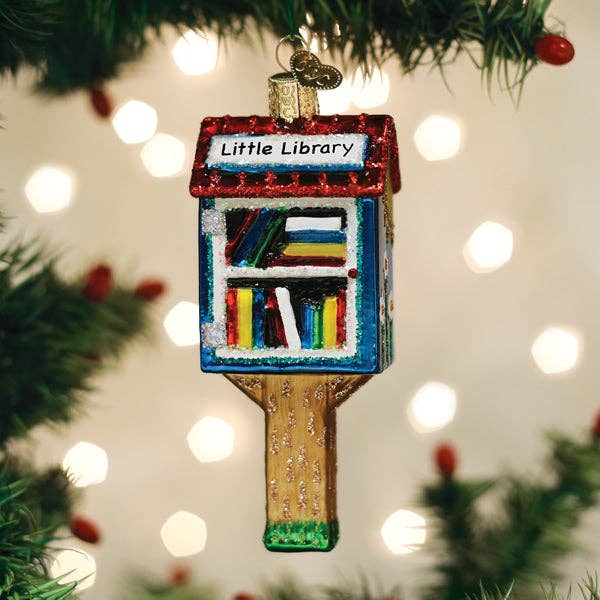 Hanging library-themed ornament with red sign and multicolor book display on gold post