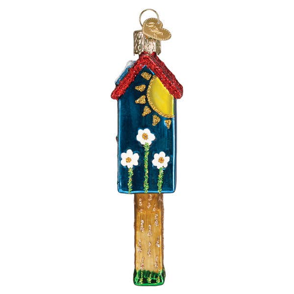 Hanging cottage ornament with red roof, blue walls, yellow door, and white flower accents
