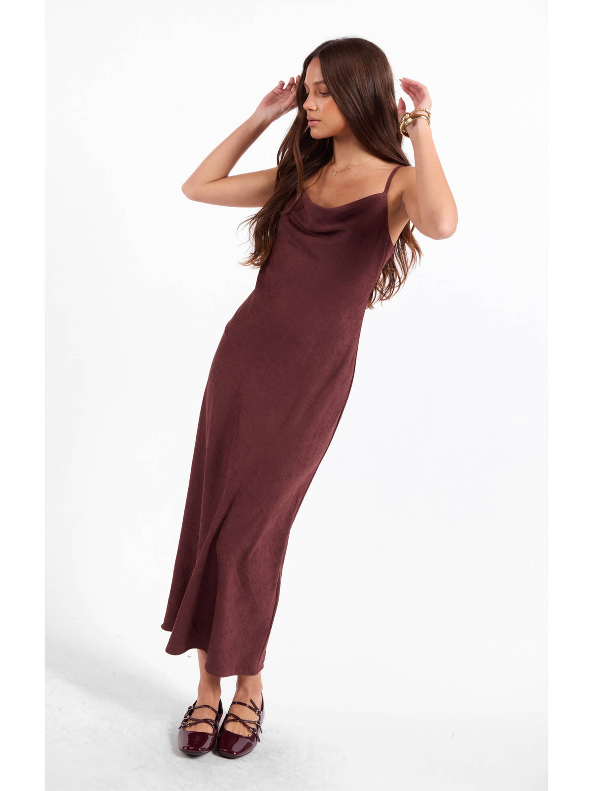 Burgundy slip dress with thin straps and cowl neckline, side slit midi length.