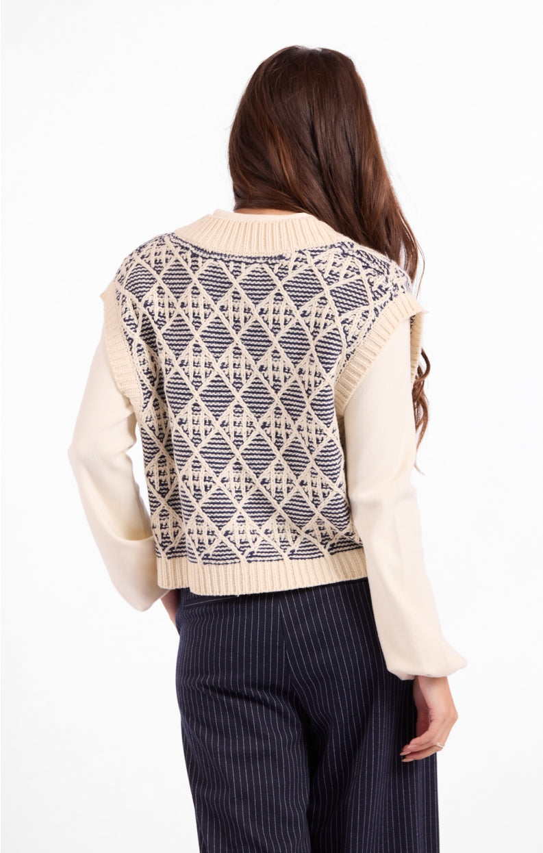Back of cream knit sweater vest with blue geometric diamond pattern and ribbed collar