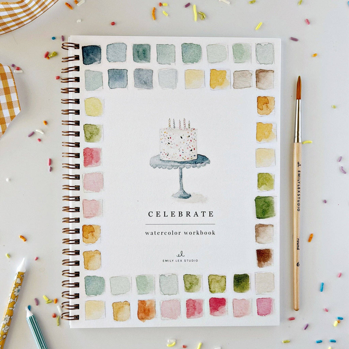 Watercolor workbook with cover art, spiral binding, and painted color palette.