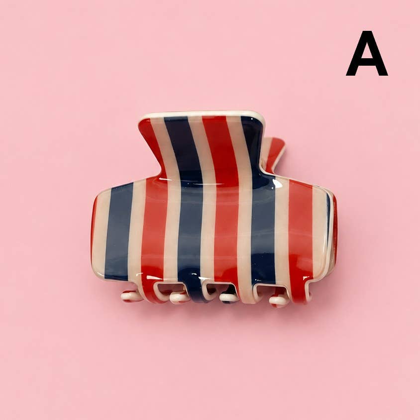 Hair claw clip with red, white, and navy vertical stripes and four prongs
