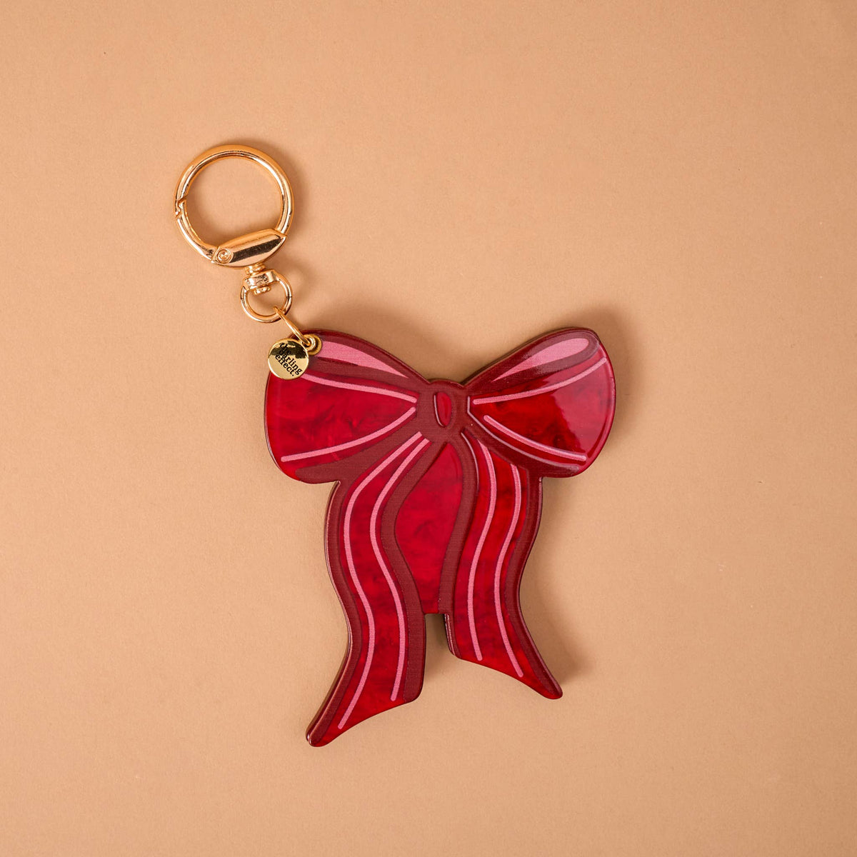 Red mini mirror bag charm with gold keyring and bow, glossy red enamel