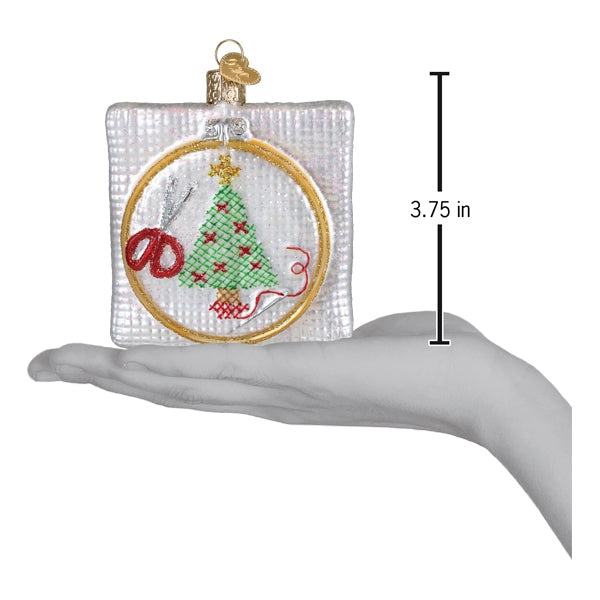 Small round cross-stitch Christmas ornament, 3.75 in, with green tree and red accents