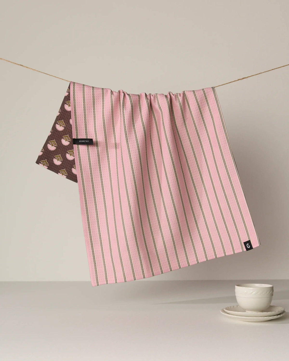 Pink striped kitchen towel with side floral panel and hanging loop