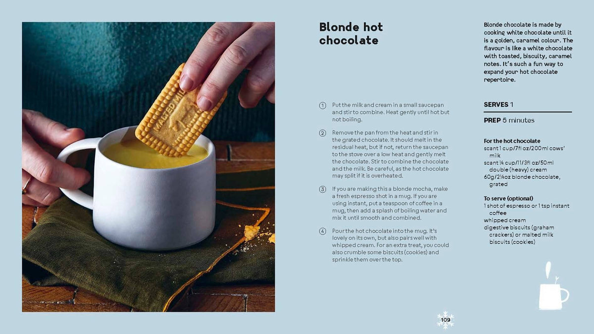 Blonde hot chocolate in white mug with gingerbread cookie on top