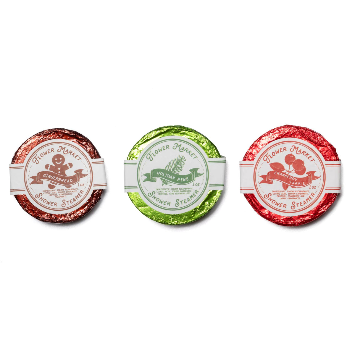 Three round shower steamer tablets: brown, green, and red label discs