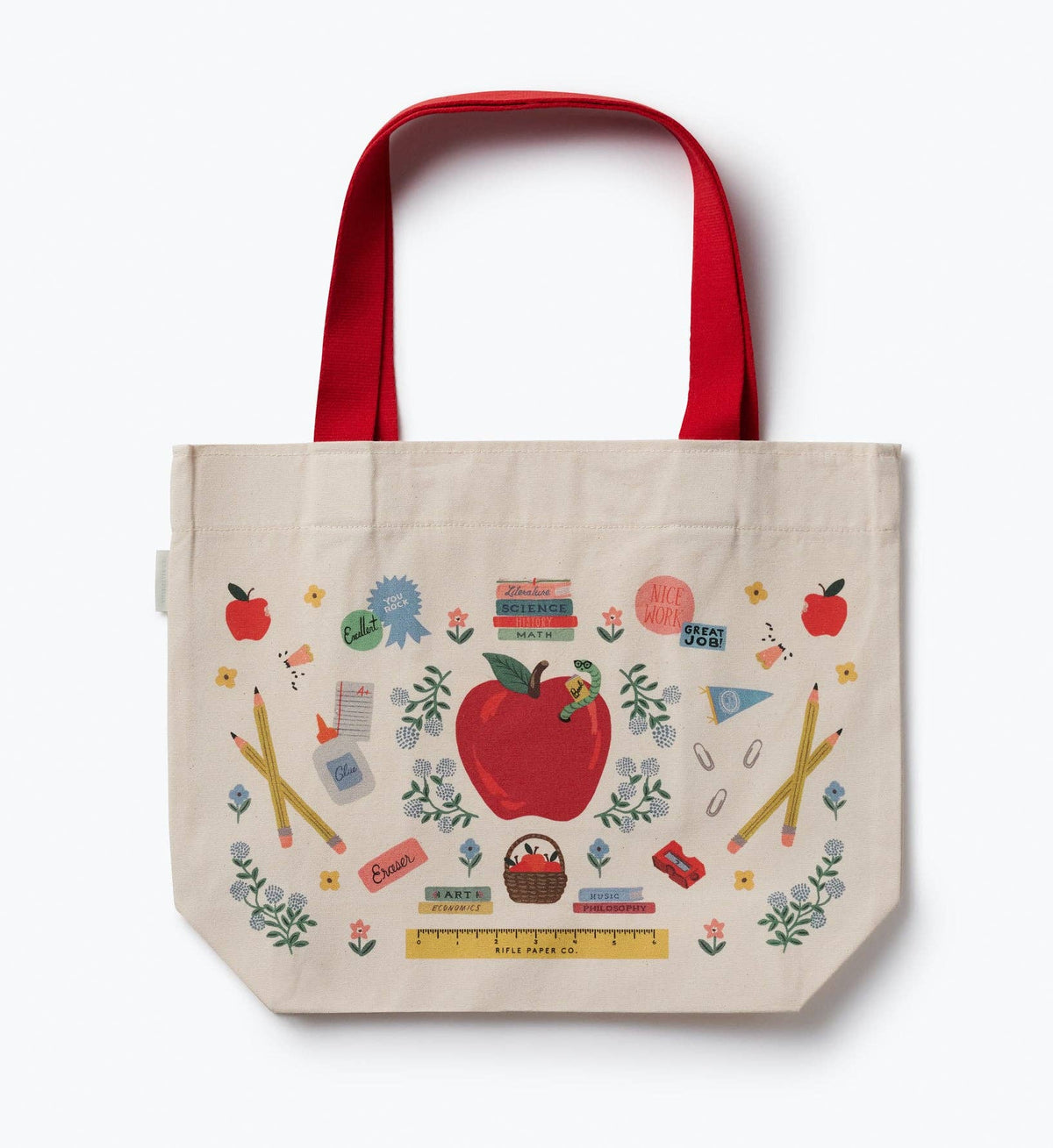 Cream canvas tote bag with red handles and school-themed apple print