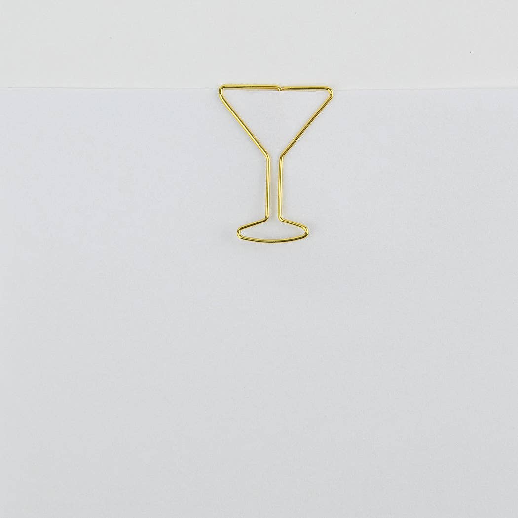 Single gold martini glass paper clip on a plain background