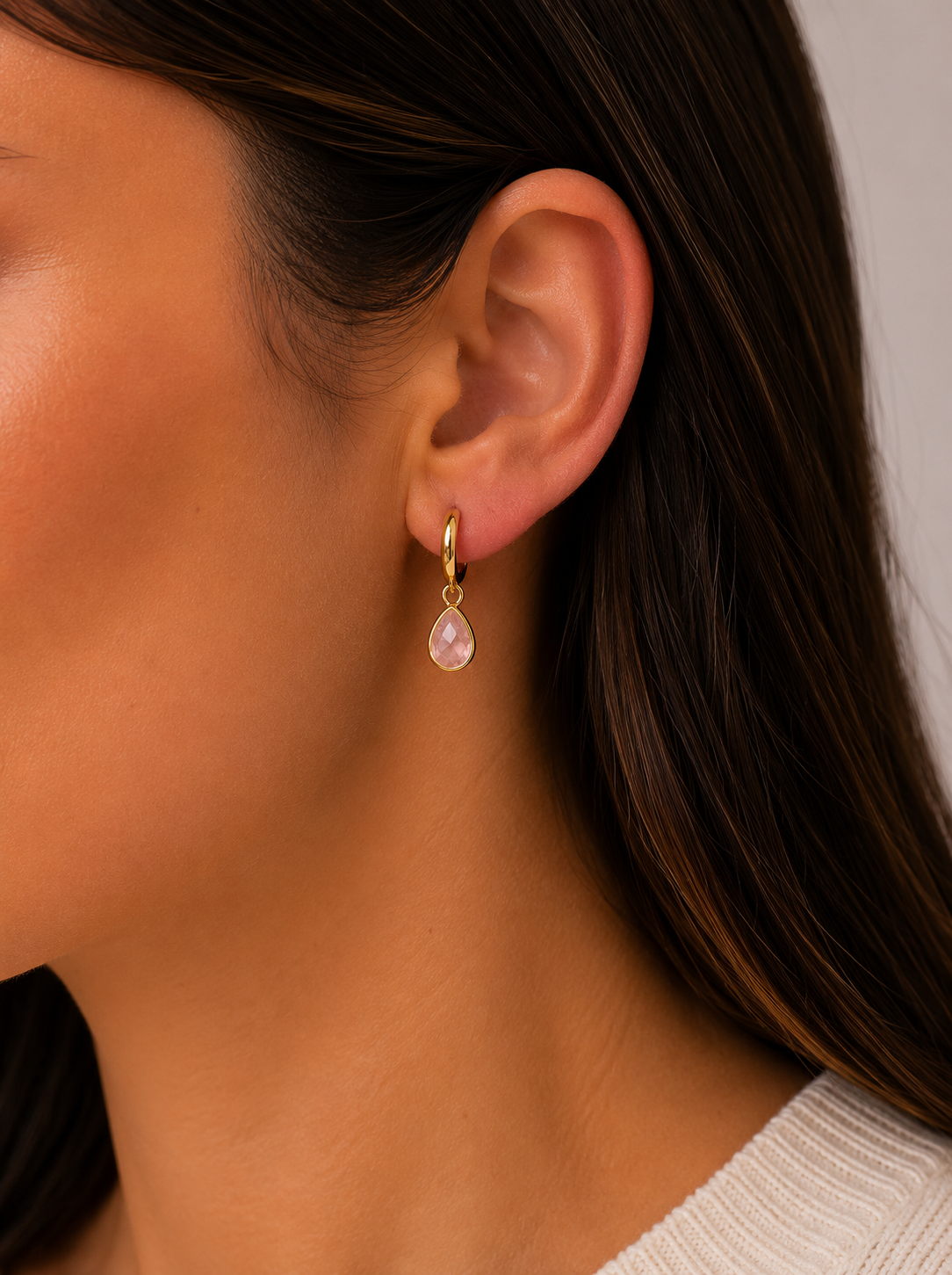 Gold hoop earrings with dangling rose quartz teardrop charms