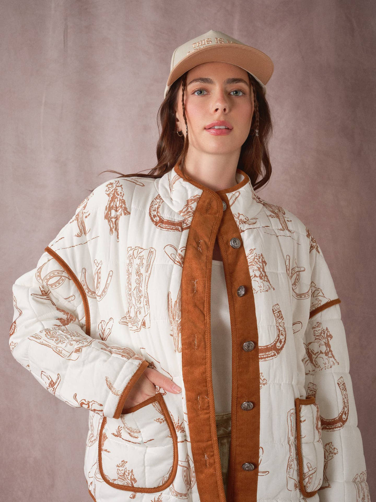 Western quilted jacket with white cowboy print, brown cord front, snap buttons, pockets