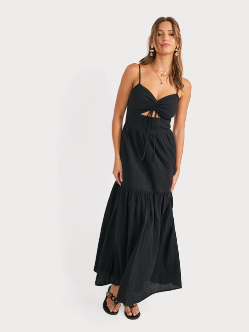 Black maxi dress with ruched bodice, spaghetti straps and tiered ruffle skirt