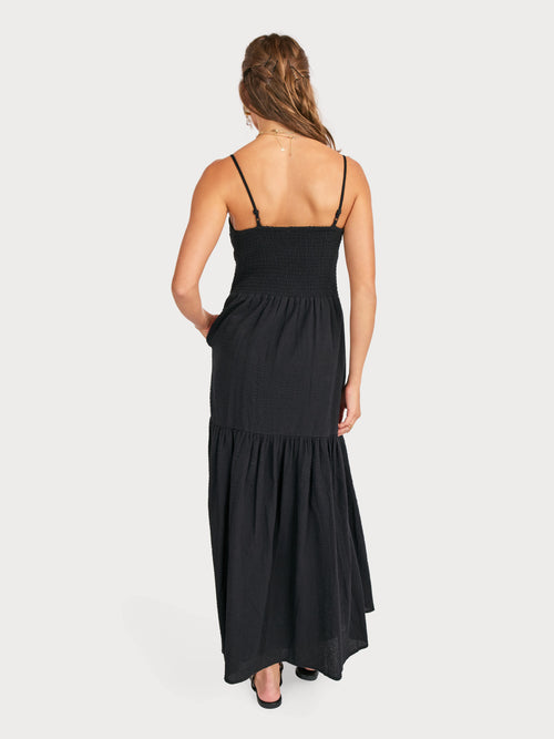 Black open-back ruched maxi dress with spaghetti straps and tiered ruffle skirt