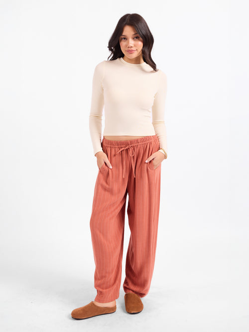 Cream crewneck long-sleeve top, fitted knit with crew neckline and slim silhouette