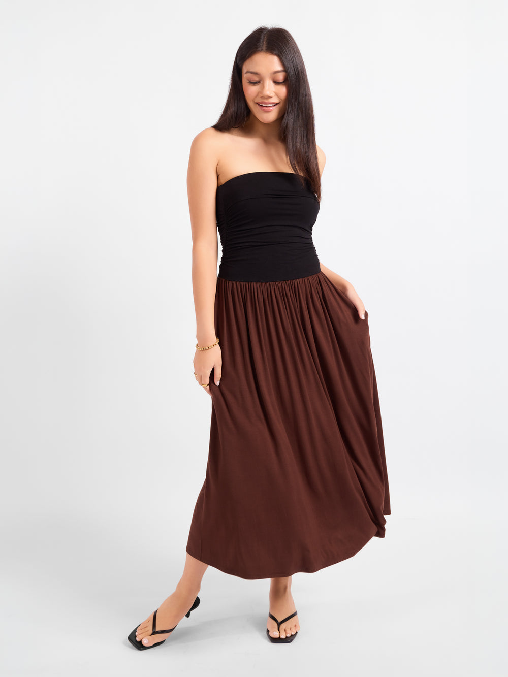 Strapless midi dress with black ruched bodice and brown gathered skirt