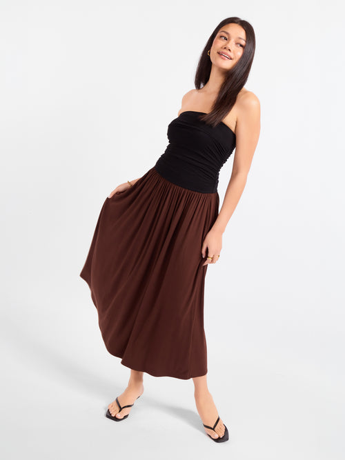 Strapless midi dress with black fitted top and flowing brown gathered skirt